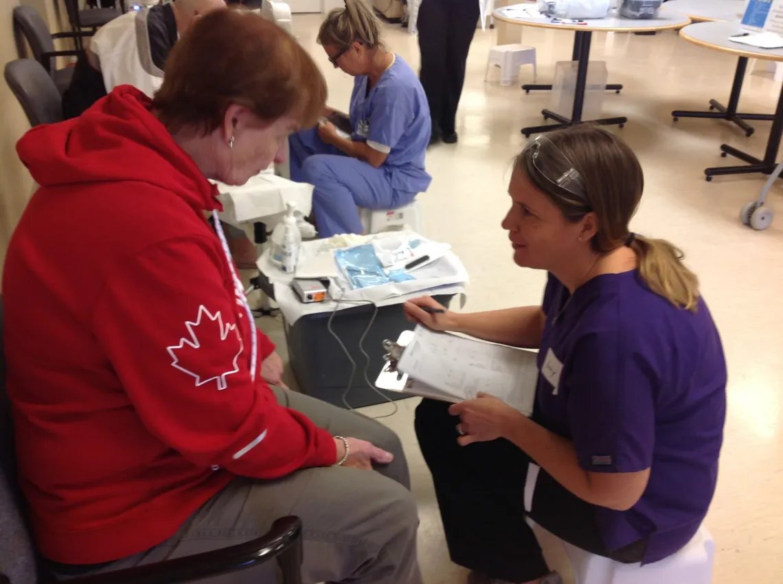 A PEDEd nurse working with a client during clinical education